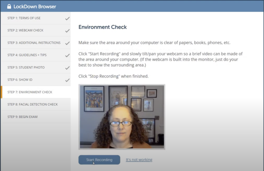 Respondus LockDown Browser pre-check step 7 of 9, Environment Check. Instructions say to clear the area around your computer of papers, books, and phones, click Start Recording, slowly tilt and pan the webcam to show the surrounding area, then click Stop Recording. A live webcam preview appears above a Start Recording button.